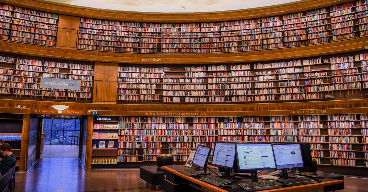 Split screen racers - Do any have local MP? - Public library with collection of colorful books on wooden bookshelves near table with computer monitors