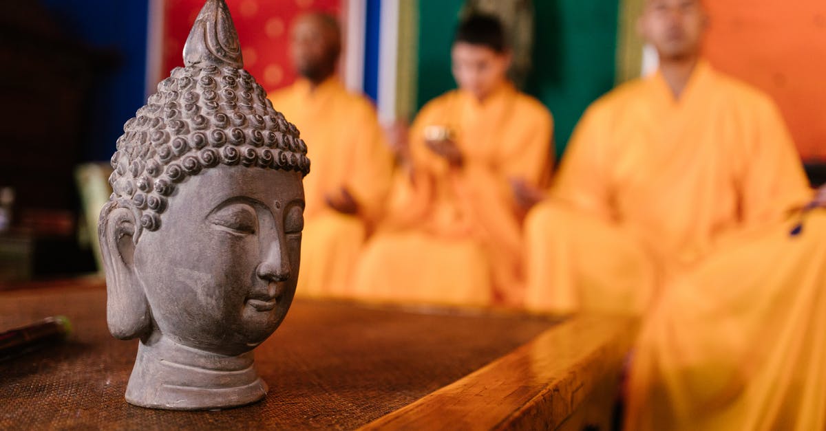 Spreading religion with caravans - Gray Ceramic Buddha Figurine on Brown Wooden Table Spreading religion with caravans - Gray Ceramic Buddha Figurine on Brown Wooden Table
