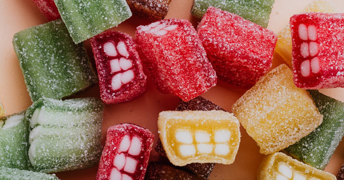 Stacked Booster Candy Crush - Set of colorful sour gummy sweets in sprinkle assorted chaotically on beige surface Stacked Booster Candy Crush - Set of colorful sour gummy sweets in sprinkle assorted chaotically on beige surface