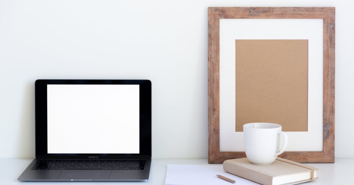 Stacking attribute modifiers - Minimalistic workplace with laptop and empty frame with office attributes during coffee break Stacking attribute modifiers - Minimalistic workplace with laptop and empty frame with office attributes during coffee break