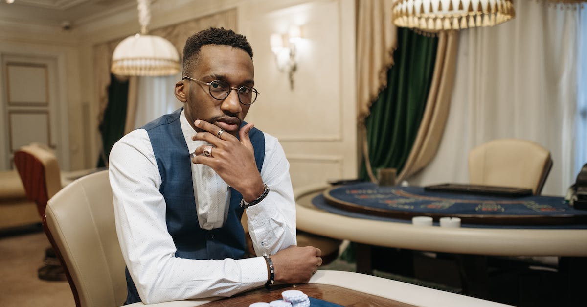 Stacking player on mobs - A Man Sitting in beside a Gaming Table While Seriously Looking at Camera Stacking player on mobs - A Man Sitting in beside a Gaming Table While Seriously Looking at Camera