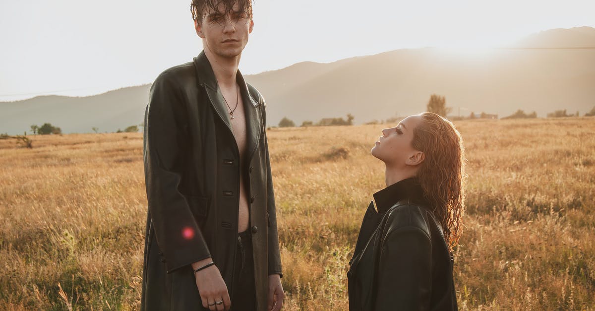 Stardew Valley : Exits appearance in mines - Extravagant couple wearing black jackets standing in meadow with dry grass against hills in sunny weather Stardew Valley : Exits appearance in mines - Extravagant couple wearing black jackets standing in meadow with dry grass against hills in sunny weather
