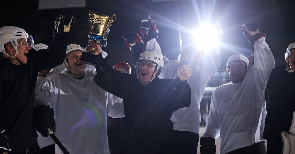 Started game before trophy support; after update (which adds trophies), they still can't be earned? - A Group of Men Celebrating their Win on a Hockey Competition