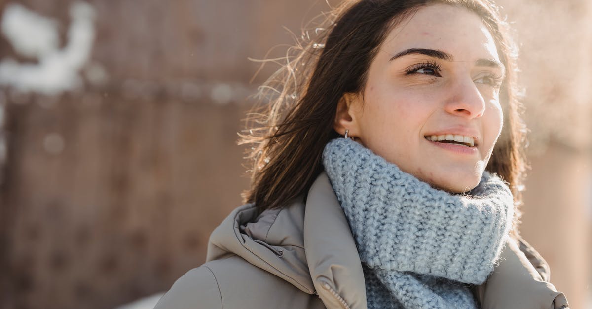 Steam error when adding friends - Content young brunette in blue sweater and warm jacket standing on snowy city street on cold sunny day and looking away
