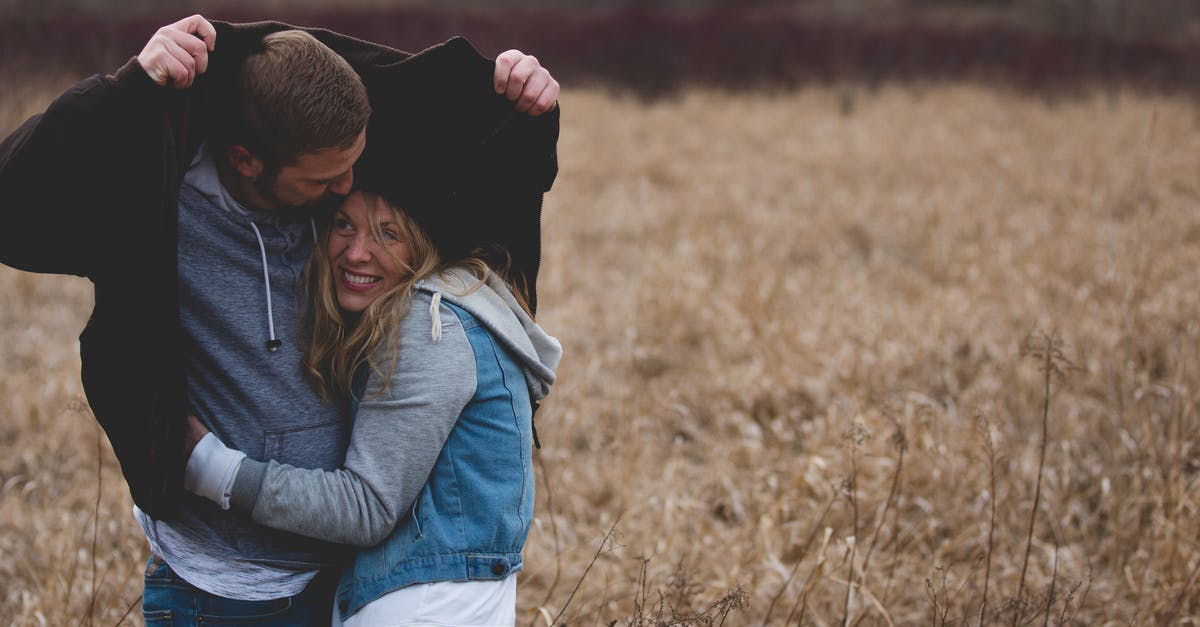 Steam Family Sharing - can it go both ways? - Man and Woman Hugging on Brown Field