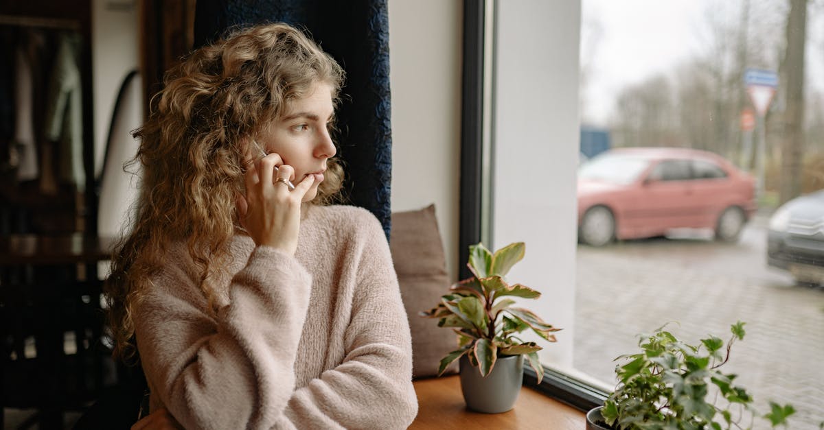 Steam mobile authenticator on a Windows phone - Woman Talking Through the Phone and Looking out the Window