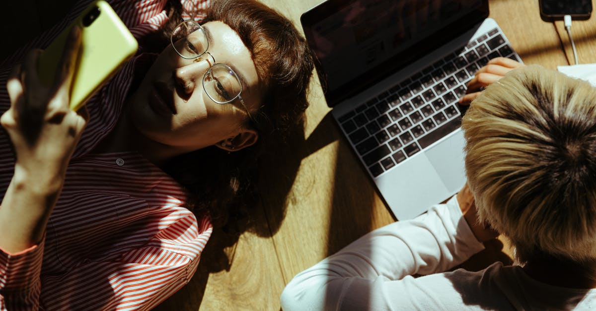 Steam remote play together no streaming screen from mac host - Crop anonymous freelancer using laptop near girlfriend chatting on smartphone Steam remote play together no streaming screen from mac host - Crop anonymous freelancer using laptop near girlfriend chatting on smartphone