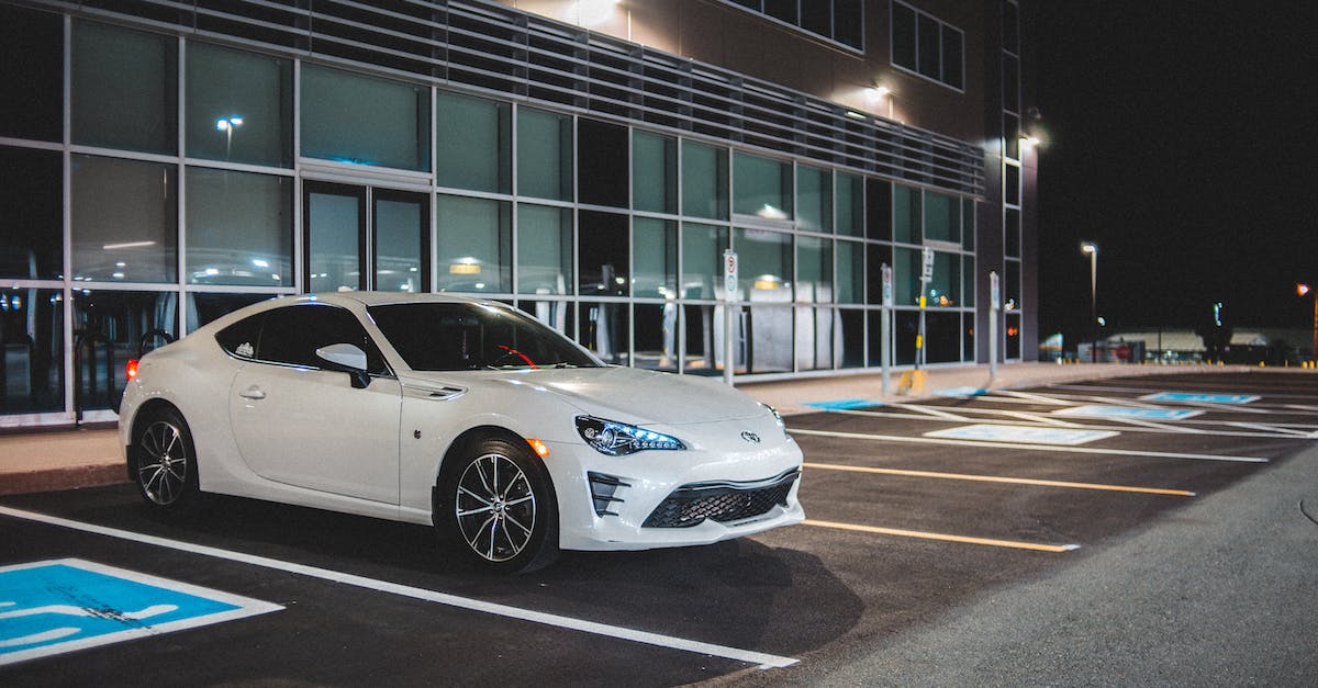Steam says not enough space even though files are already on my hard drive - Expensive white automobile on parking space with marking lines near building with glass wall in street at night time