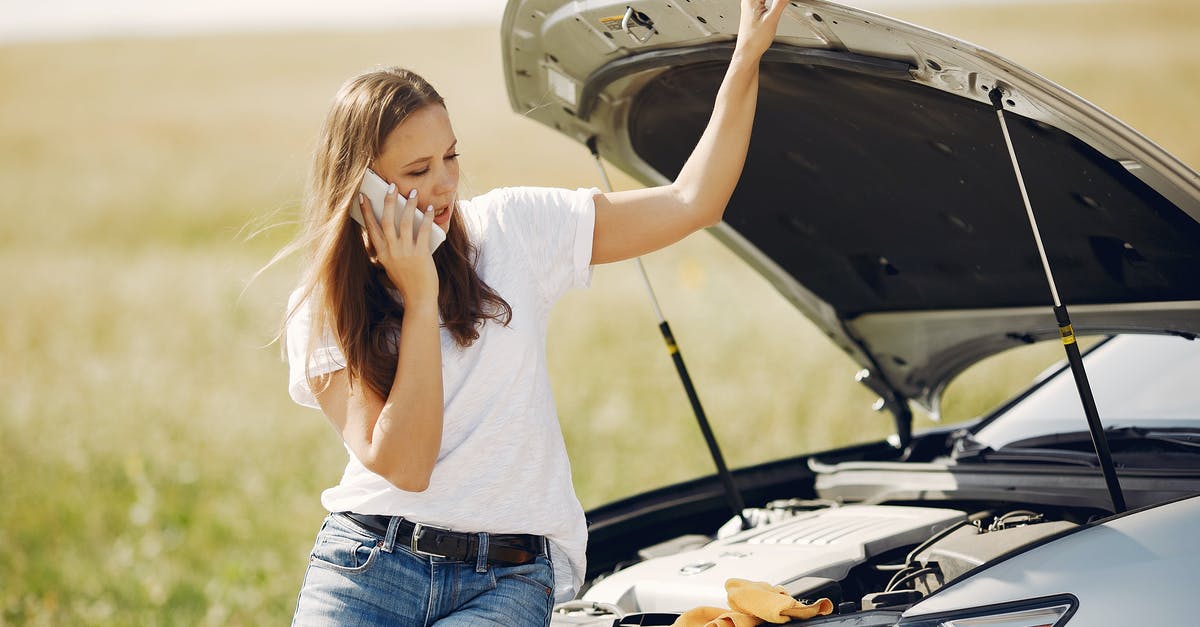 SteelSeries Engine 3 won't open - Upset woman using smartphone near broken automobile in countryside during car trip