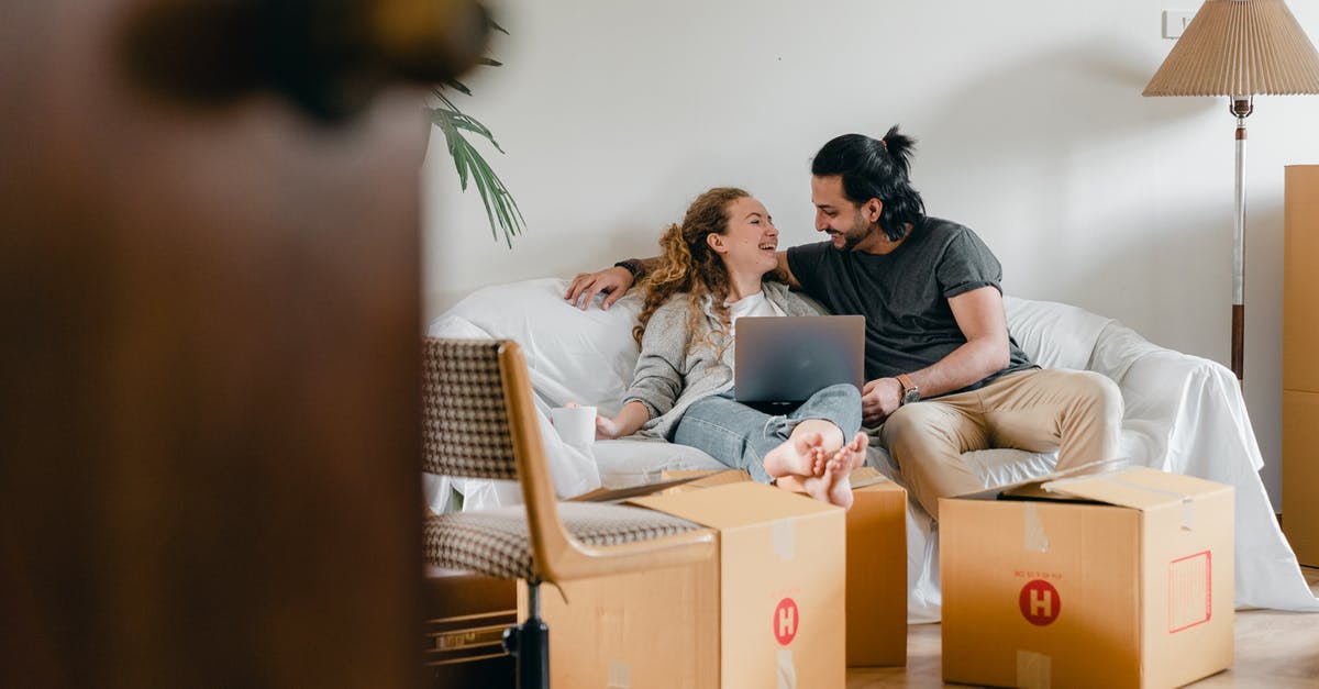 Stellaris - How can I move my civilian (scientist) ships to other empires territory? - Cheerful couple in casual clothes sitting on comfortable sofa with laptop and looking at each other while moving to new apartment