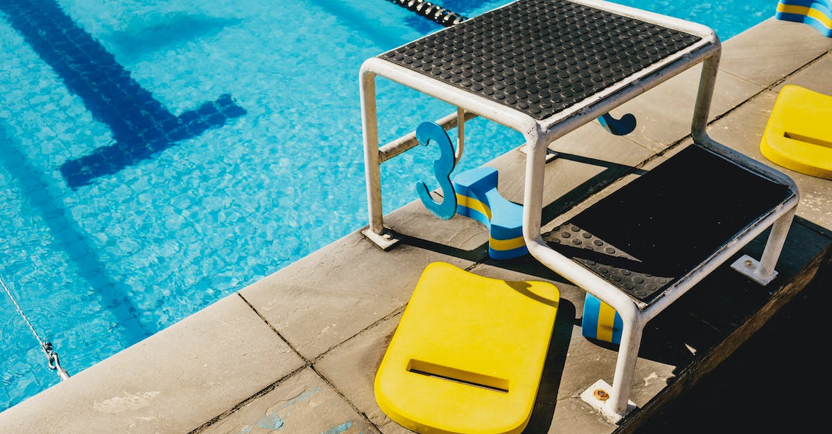 Stuck in a hole with water above me - Diving board in swimming pool with blue water