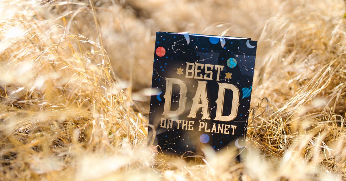 Stuck with a growing pop of a species that is no longer present on the planet - A Blue Gift Bag on Dried Grass Stuck with a growing pop of a species that is no longer present on the planet - A Blue Gift Bag on Dried Grass