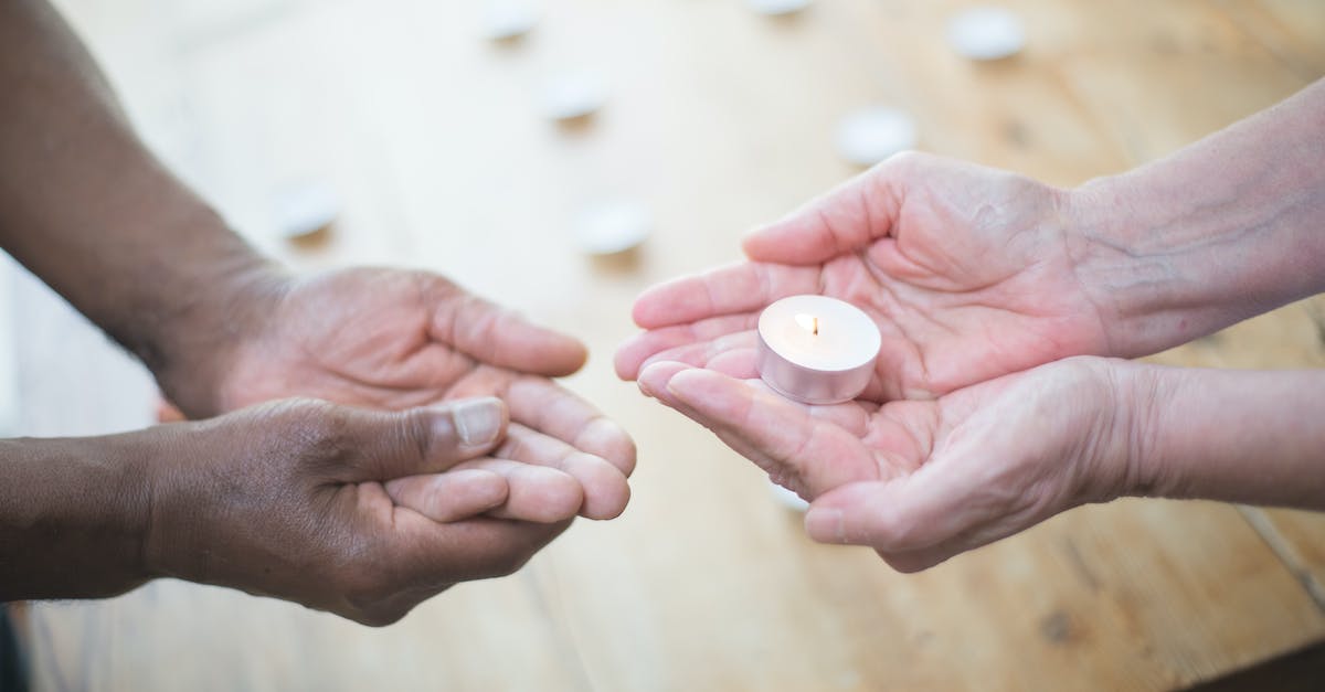 Stuck with Only a Candle to my Name - Person Holding White Round Ornament Stuck with Only a Candle to my Name - Person Holding White Round Ornament