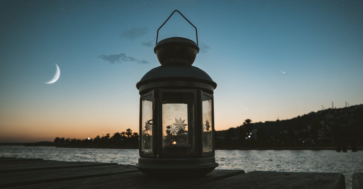 Sun and moon event differences - Gray Metal Candle Lantern on Boat Dock