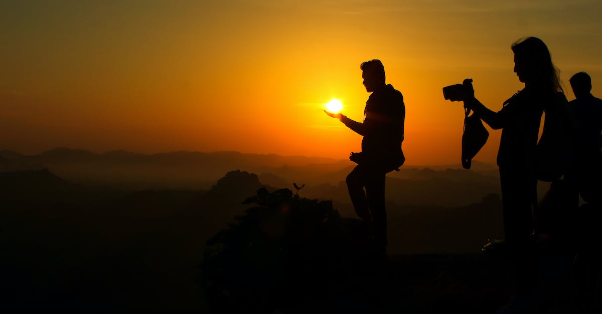 Super Mario Sunshine Camera - Asian photographer hold sun sunrise in silhouette