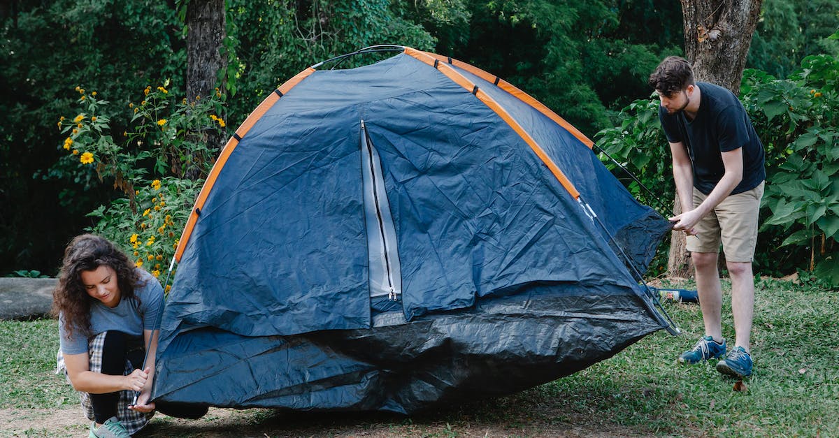 Super Secret Settings help in 1.8.8 [duplicate] - Couple of travelers setting up tent on meadow against trees and bushes during summer journey in daylight