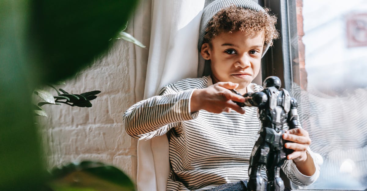 Switched Windows to Mac, do I have to buy Steam games again to play on Mac? - Cheerful black boy playing with toy at home in sunny day