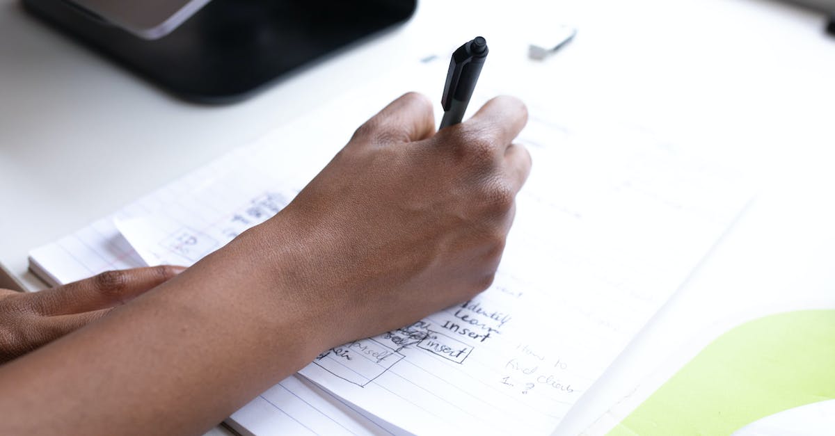 taking someone's destiny data and puting it on your account - Crop faceless employee writing on paper during workday taking someone's destiny data and puting it on your account - Crop faceless employee writing on paper during workday