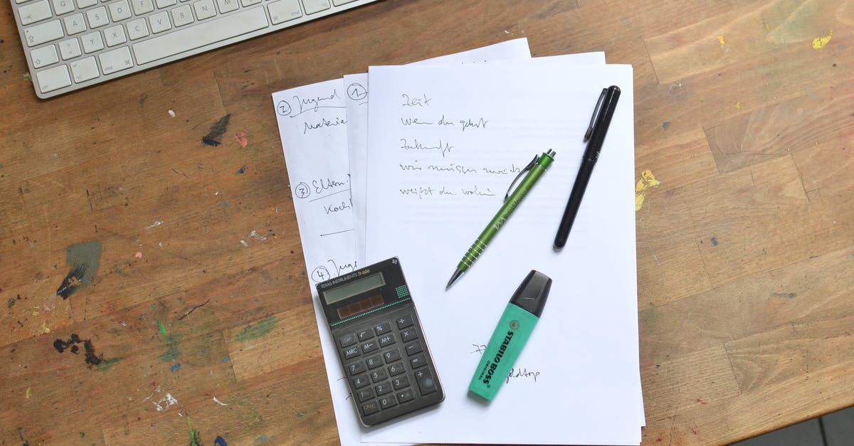 taking someone's destiny data and puting it on your account - Calculator and pens with marker placed on papers taking someone's destiny data and puting it on your account - Calculator and pens with marker placed on papers