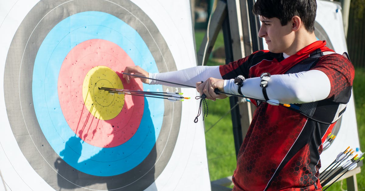 Target in Minecraft problem - Man Pulling Arrows from Archery Target Board Target in Minecraft problem - Man Pulling Arrows from Archery Target Board