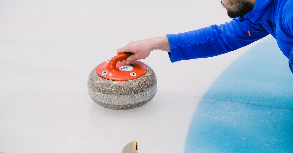 Teleport a player away from certain entities? - From above of crop concentrated player in uniform choosing trajectory of stone movement while playing curling on ice rink