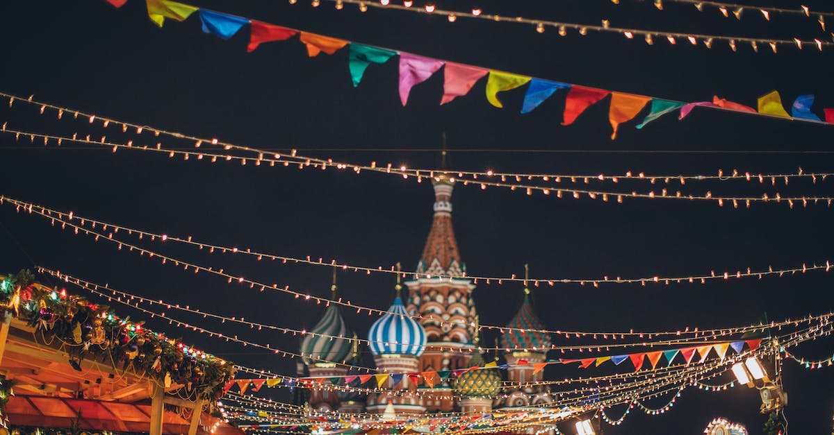 temple run 2 gold color circles - Strings of illuminated garlands hanging over holiday market on background of majestic cathedral