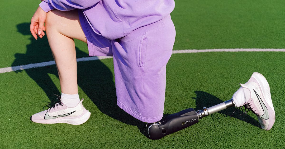 Terraria Invalid Housing? [duplicate] - Side view of unrecognizable female invalid in activewear stretching on green sports ground during training on sunny day in stadium