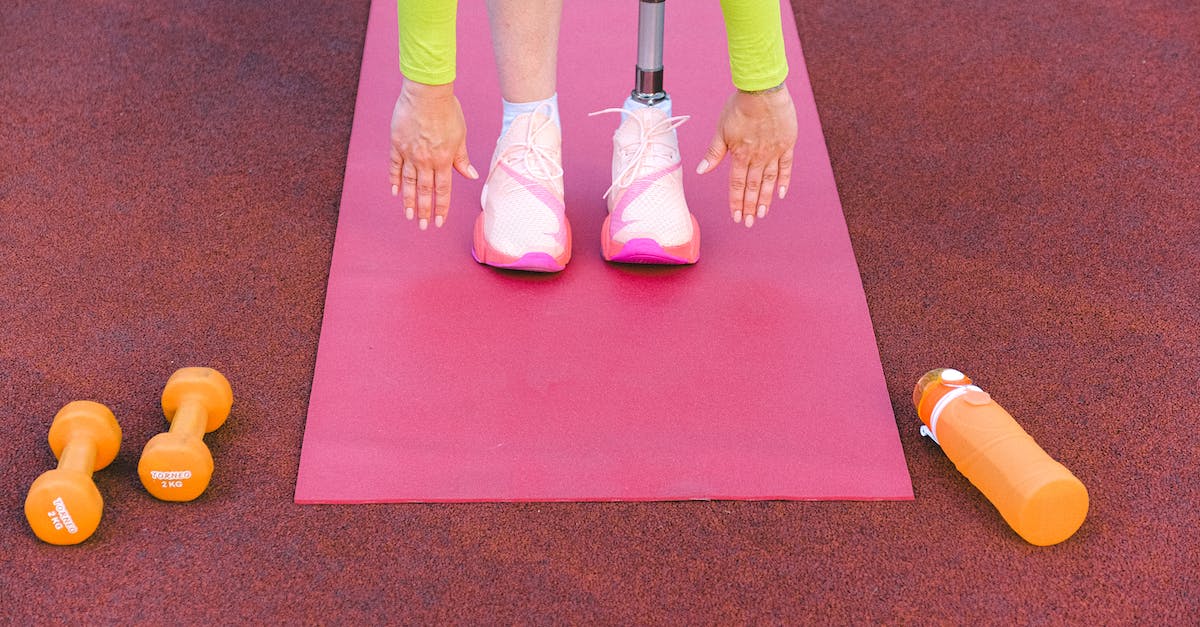 Terraria Invalid Housing? [duplicate] - Unrecognizable female athlete with leg prosthesis bending forward and stretching while trying ti touch ground during training on sports ground with dumbbells