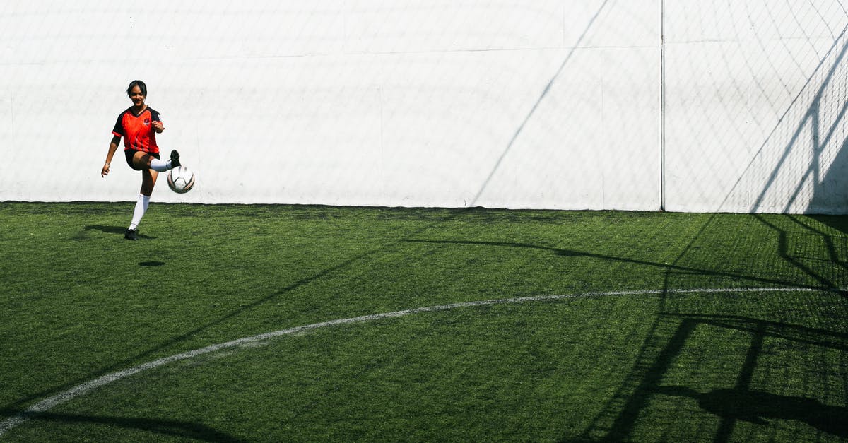 Test for all player without a score - Young African American female football player trying scoring goal in training in sunny day Test for all player without a score - Young African American female football player trying scoring goal in training in sunny day