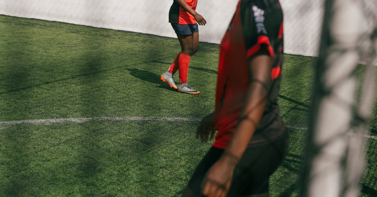 Test for all player without a score - Crop young African American female football player practicing with ball in training in sunny day Test for all player without a score - Crop young African American female football player practicing with ball in training in sunny day