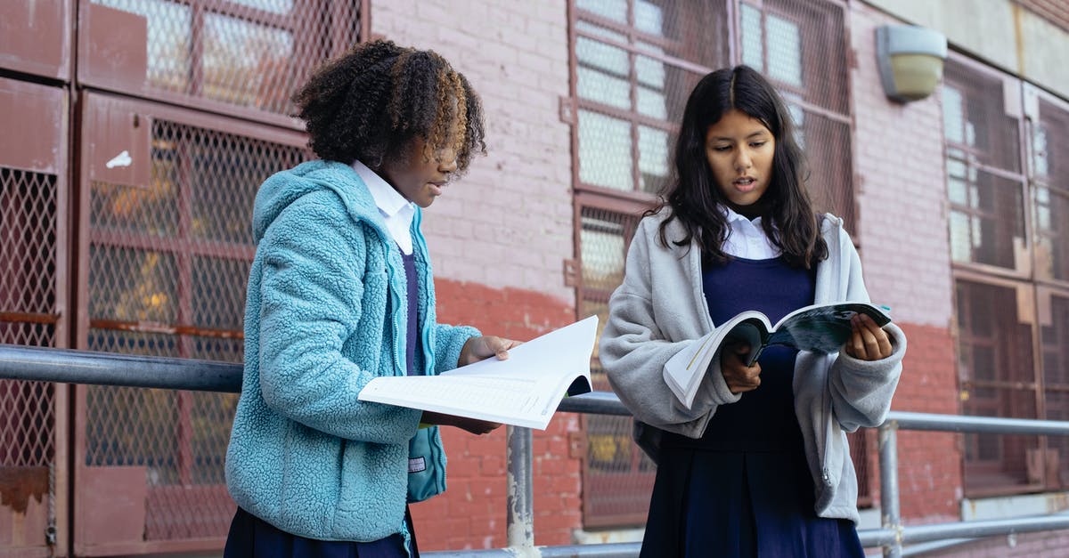 test for something in chat minecraft command blocks [closed] - Diverse pupils talking while looking at textbooks and preparing for test near school