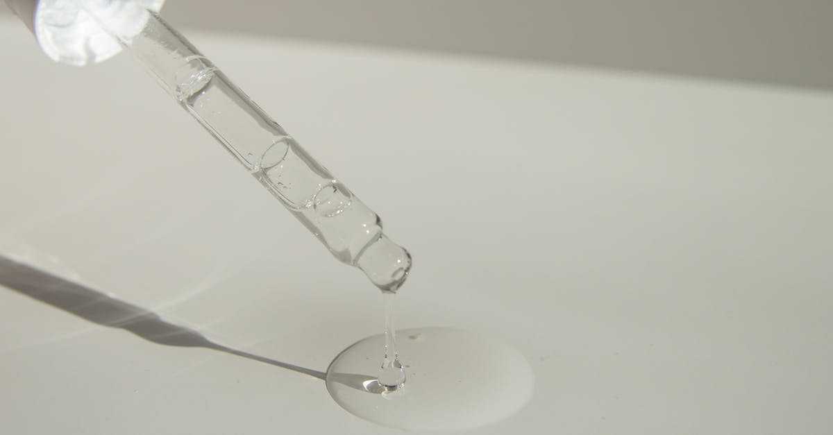 Test true if NO ArmorStand - Anonymous person pouring liquid product on table with pipette Test true if NO ArmorStand - Anonymous person pouring liquid product on table with pipette