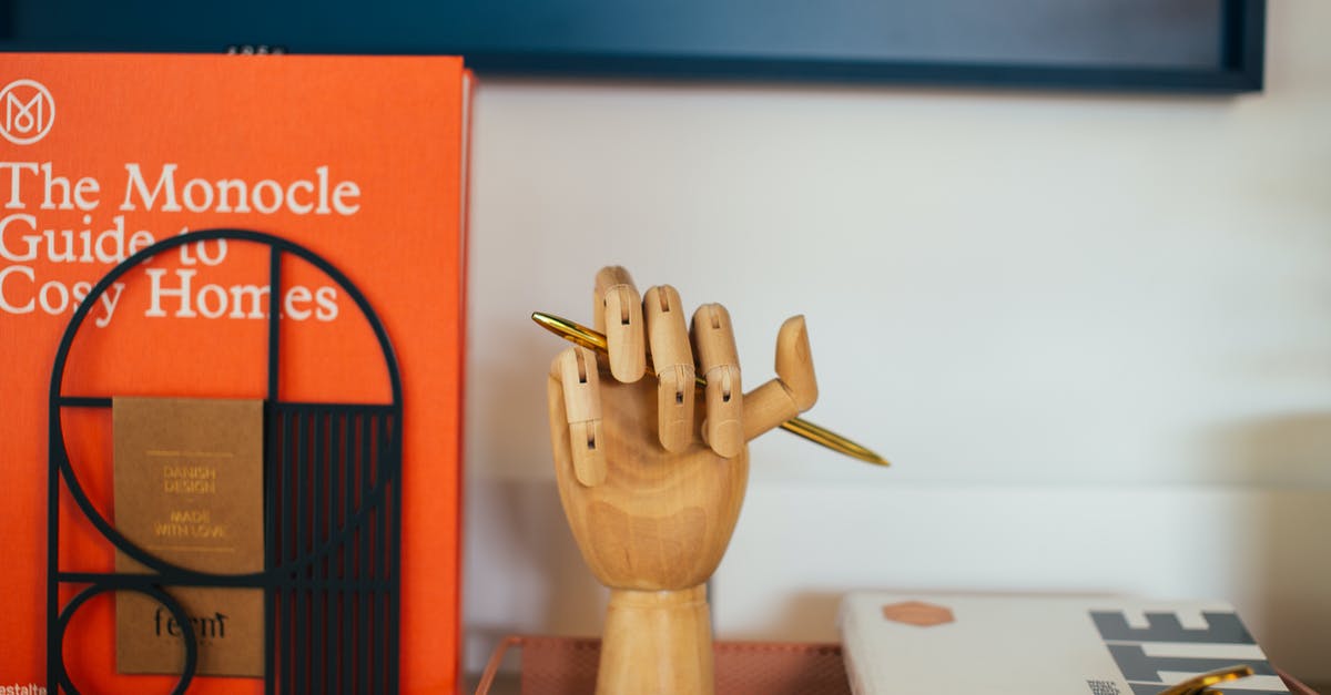 Testfor an item in player's hand - Encyclopedia placed near wooden decorative hand shaped pen holder