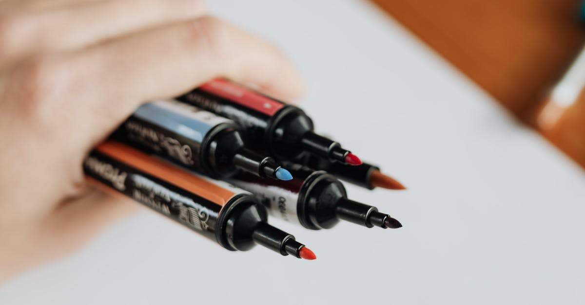 Testfor an item in player's hand - Crop unrecognizable person showing set of markers at work