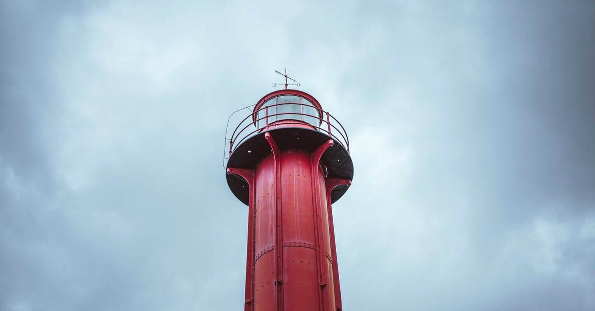 /testforblock command on beacon beam - From below of red metal lighthouse on lonely surface under cloudy sky in daylight