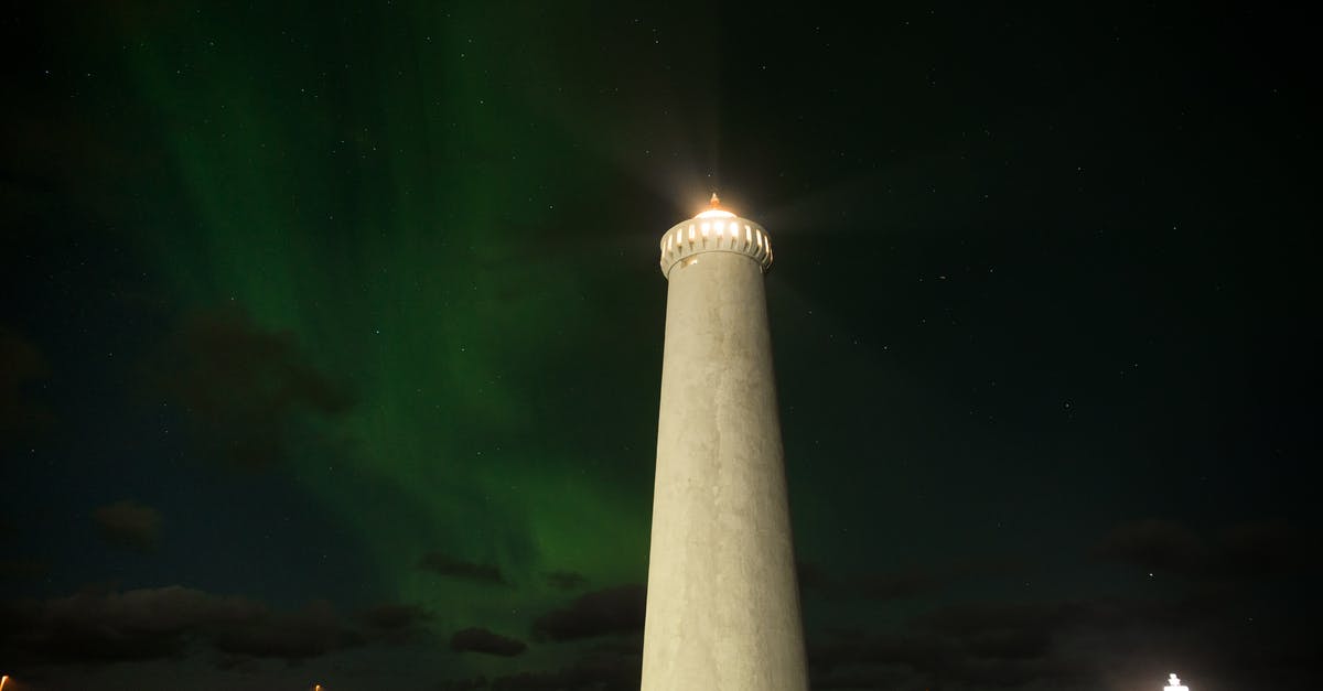 /testforblock command on beacon beam - Northern lights over lighthouse against night sky