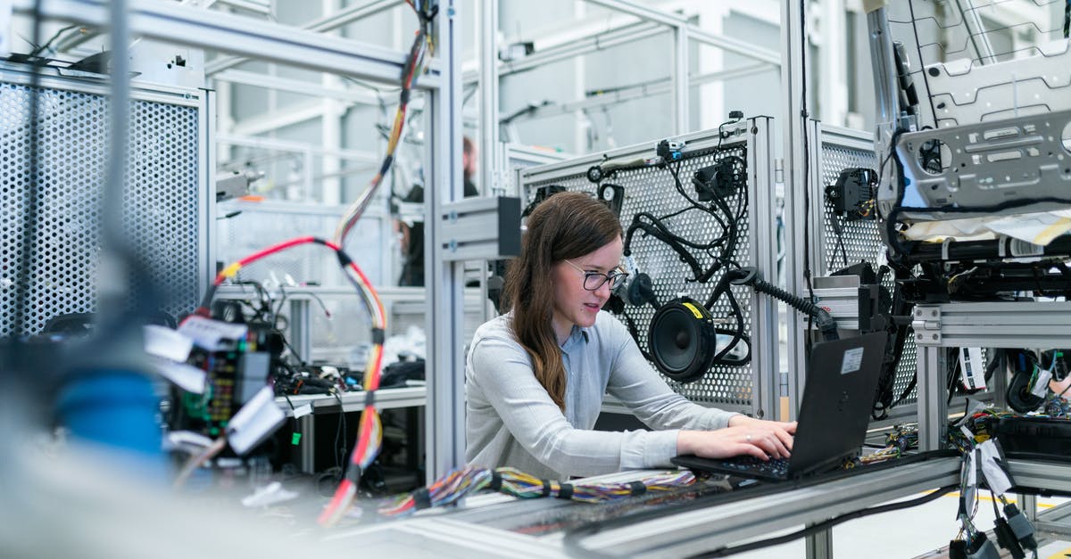 Testing for a Certain Structure - Photo Of Female Engineer Working On Her Workspace