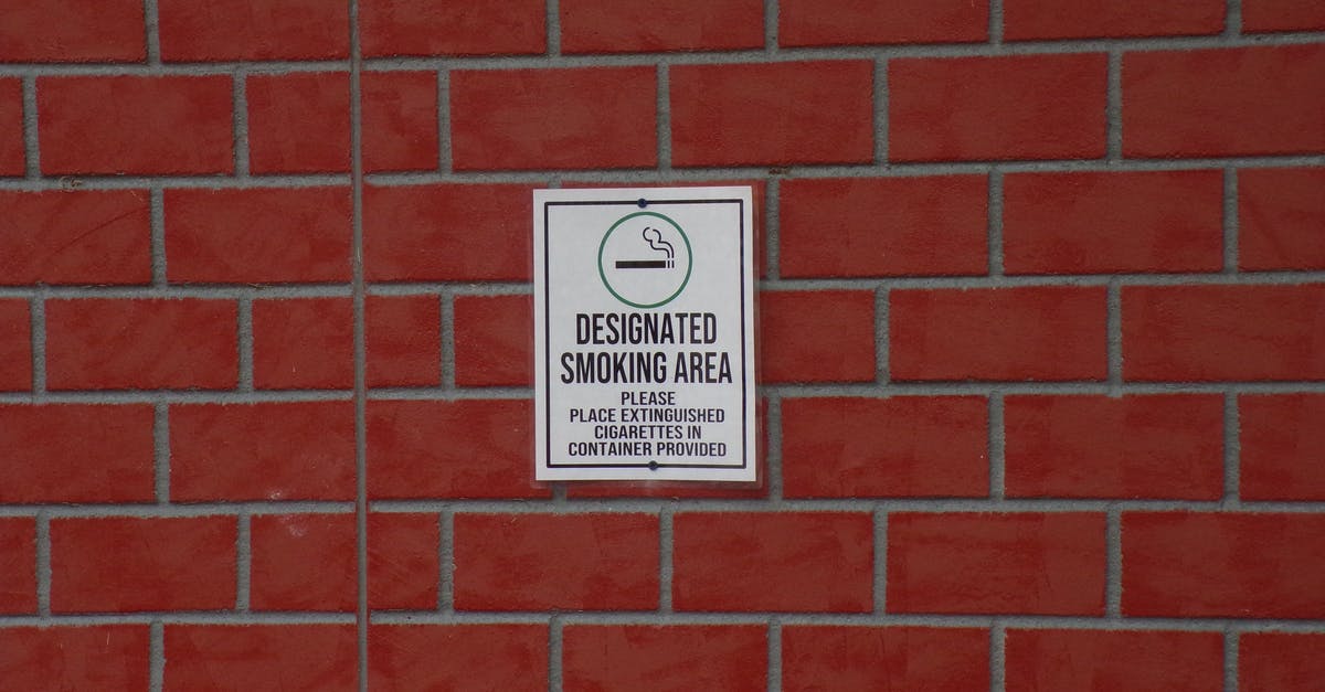 Testing for players within a specified rectangular area - Building with brick wall and signboard with title indicating smoking area with symbol of cigarette