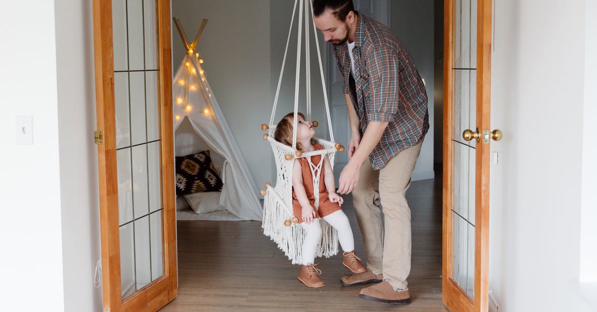 TF2 Game Server Map Cycle Help - Side view of young male parent in casual wear and little daughter looking at each other playing together in cozy room at home