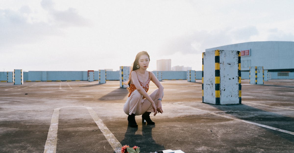 TF2- how to deal with Roof Wranglers - Woman in White Tank Top and Black Pants Sitting on Gray Concrete Floor