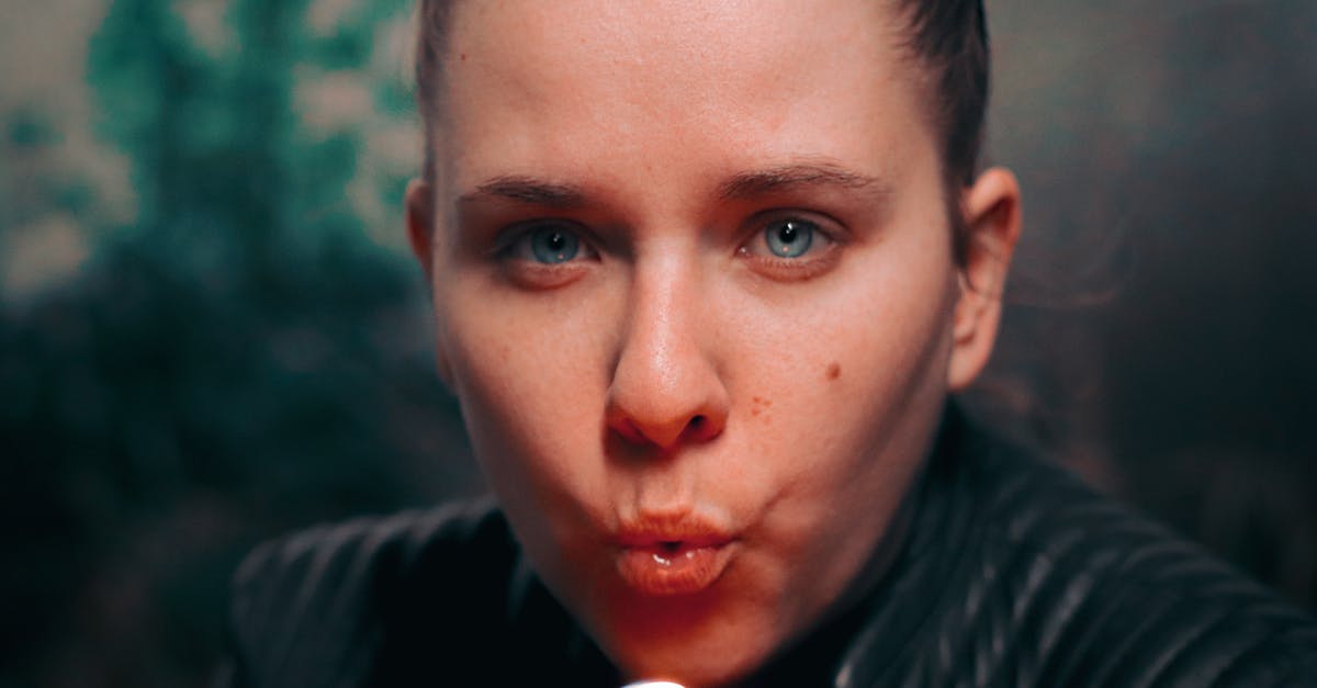 The fire keeper's eyes (alternate ending) - Close-Up Photo of Woman Blowing a Lighter The fire keeper's eyes (alternate ending) - Close-Up Photo of Woman Blowing a Lighter