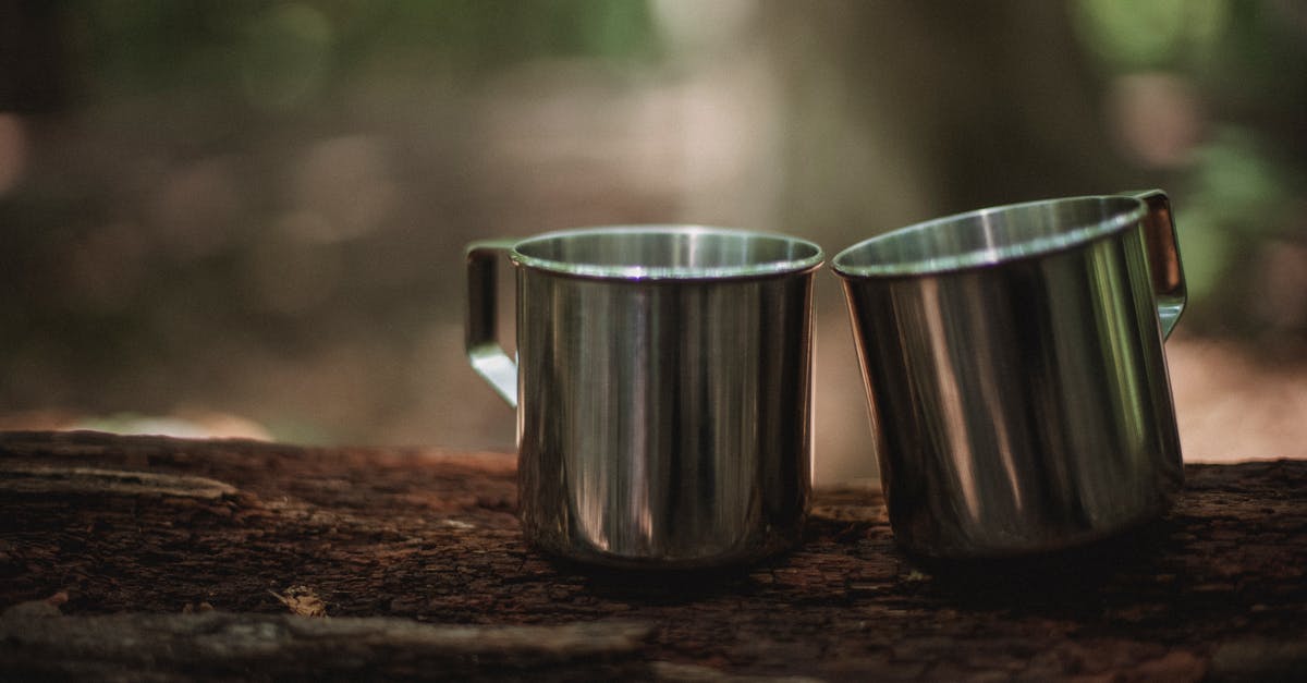 The Heide Knight in the Forest of Fallen Giants will not spawn - Pair of shiny hiking mugs on dry tree trunk in summer forest on blurred background