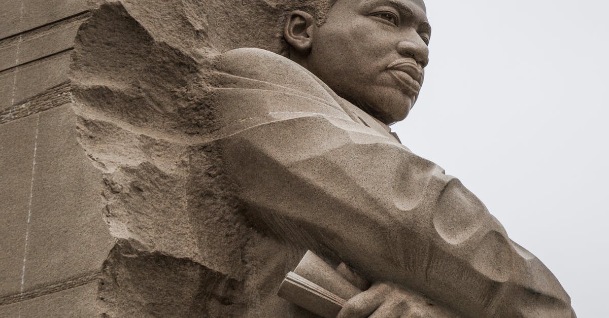 The leader of our clan kicked us and left the clan - Granite statue of civil rights movement leader against overcast sky The leader of our clan kicked us and left the clan - Granite statue of civil rights movement leader against overcast sky