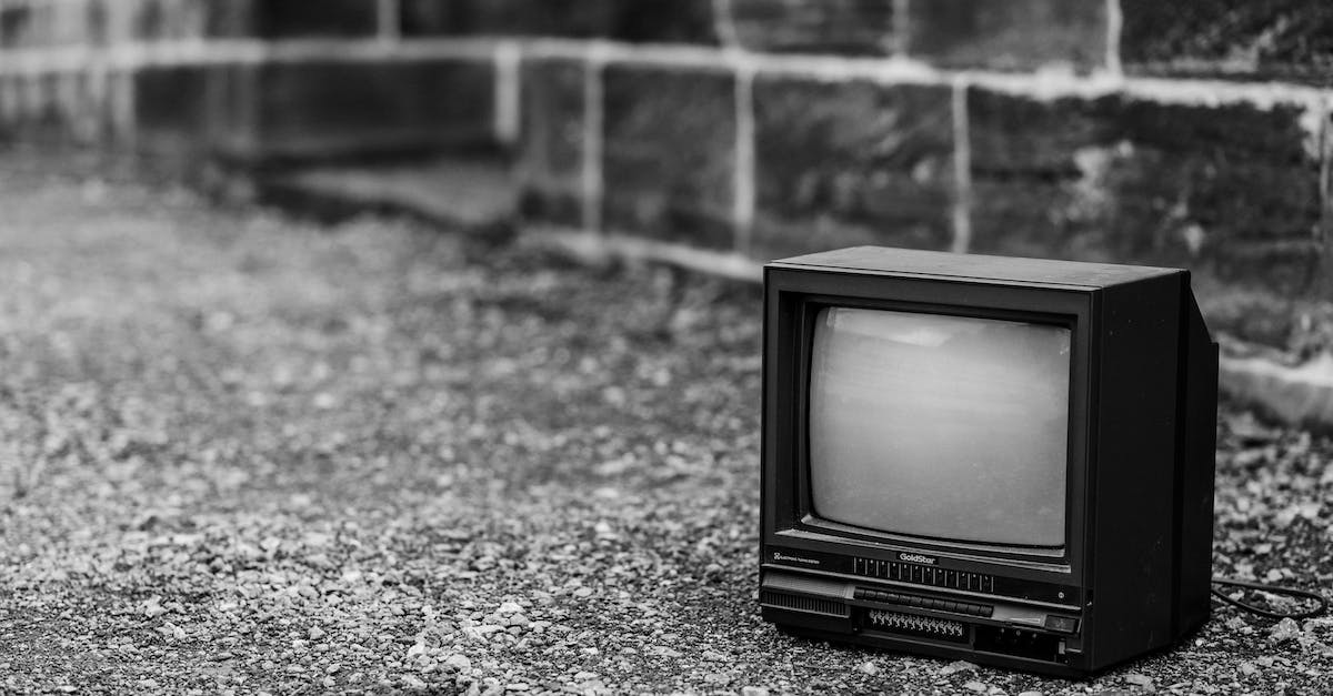 the mame.ini file path not used - Black and white of old fashioned television placed on pathway near stone fence in city on street on blurred background the mame.ini file path not used - Black and white of old fashioned television placed on pathway near stone fence in city on street on blurred background