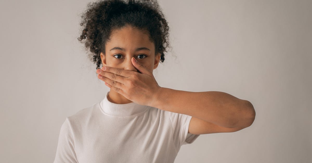 The Moon locked me in secret room during Challange #3 - Concerned African American teenage girl in white outfit looking at camera while covering mouth with hand on gray background in studio The Moon locked me in secret room during Challange #3 - Concerned African American teenage girl in white outfit looking at camera while covering mouth with hand on gray background in studio