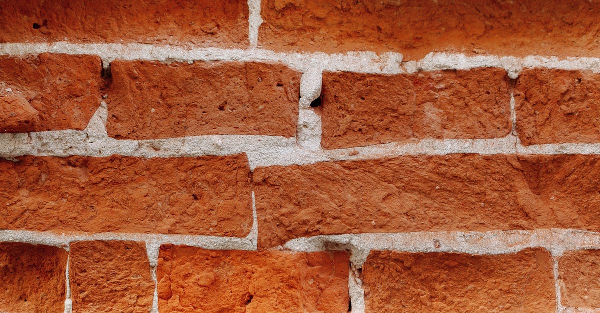 The strange wall or background in the cavern layer of Terrarria - Textured backdrop of bricks between cement layers with uneven surface and dense structure in daytime
