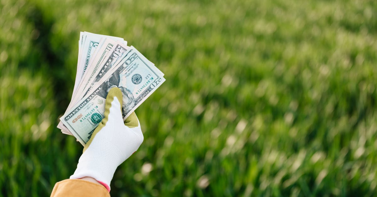 There are so many Pokemon in the park across from my house... but 80% are Zubats. Why doesn't the park spawn different Pokemon? - Crop anonymous gardener showing different dollar banknotes on grass background