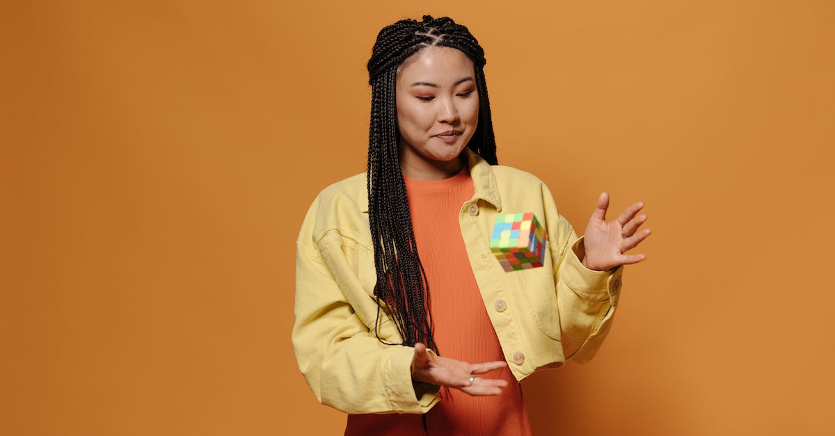 Throwing cubes in Portal 2? - Smiling Woman in Orange Dress Catching a Rubik's Cube