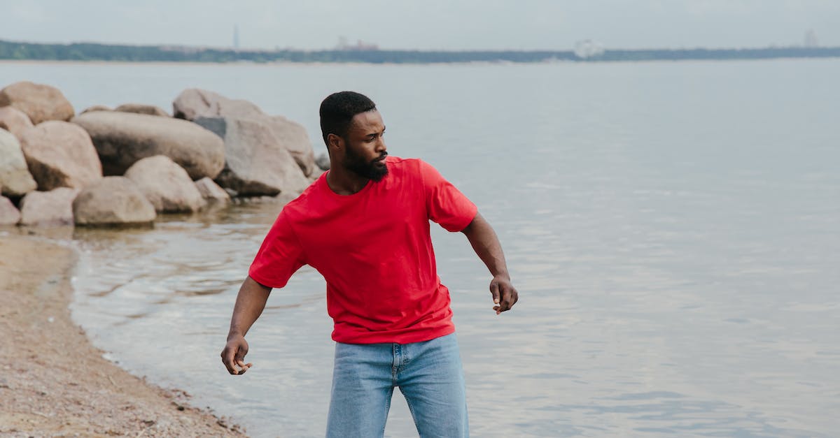 Throwing cubes in Portal 2? - Man in Red Crew Neck T-shirt and Green Shorts Standing on Gray Rock Near Body Throwing cubes in Portal 2? - Man in Red Crew Neck T-shirt and Green Shorts Standing on Gray Rock Near Body