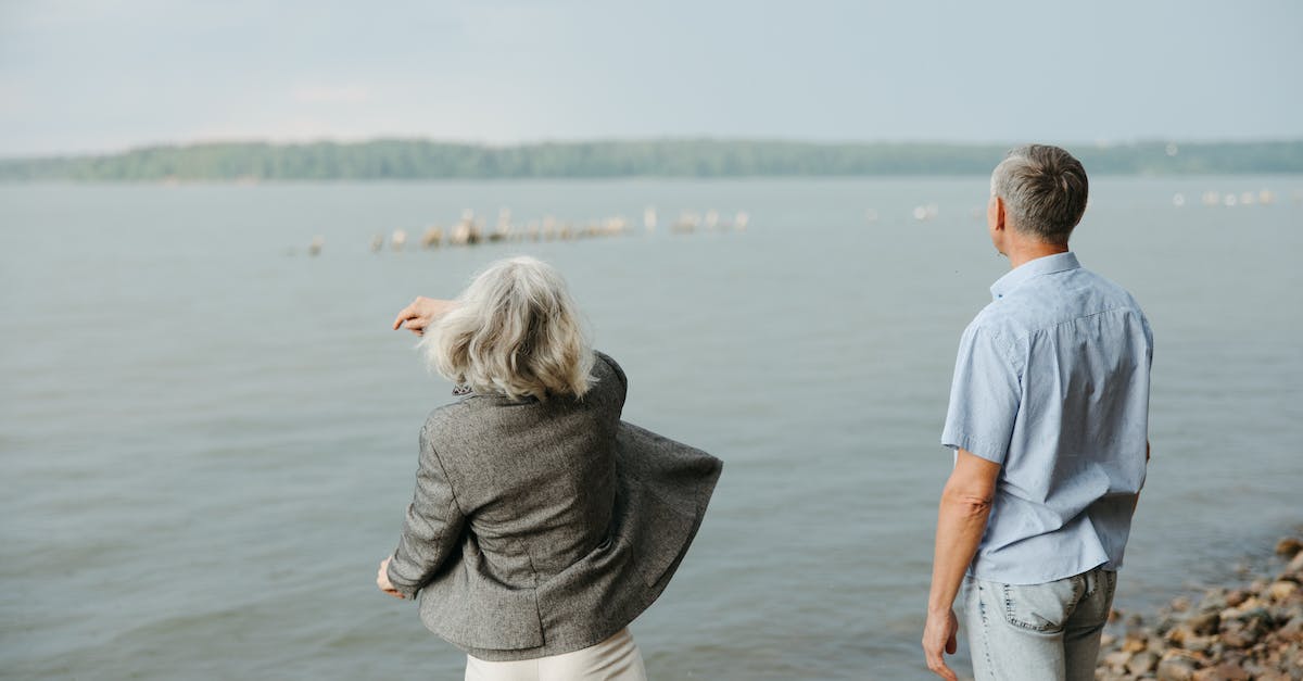 Throwing cubes in Portal 2? - Man and Woman Standing on Rock Near Body of Water Throwing cubes in Portal 2? - Man and Woman Standing on Rock Near Body of Water